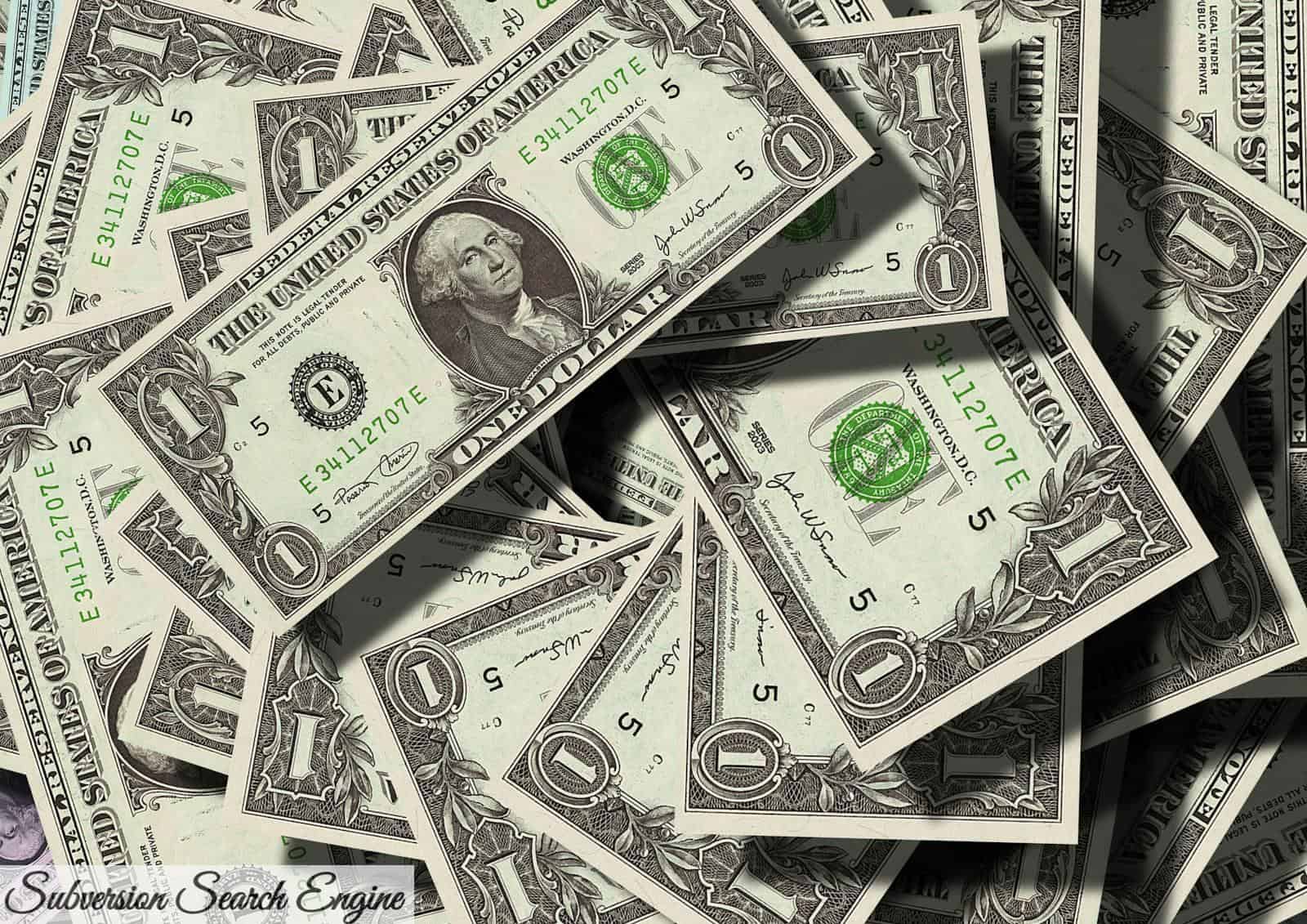 Close-up of scattered US dollar bills symbolizing finance and wealth.