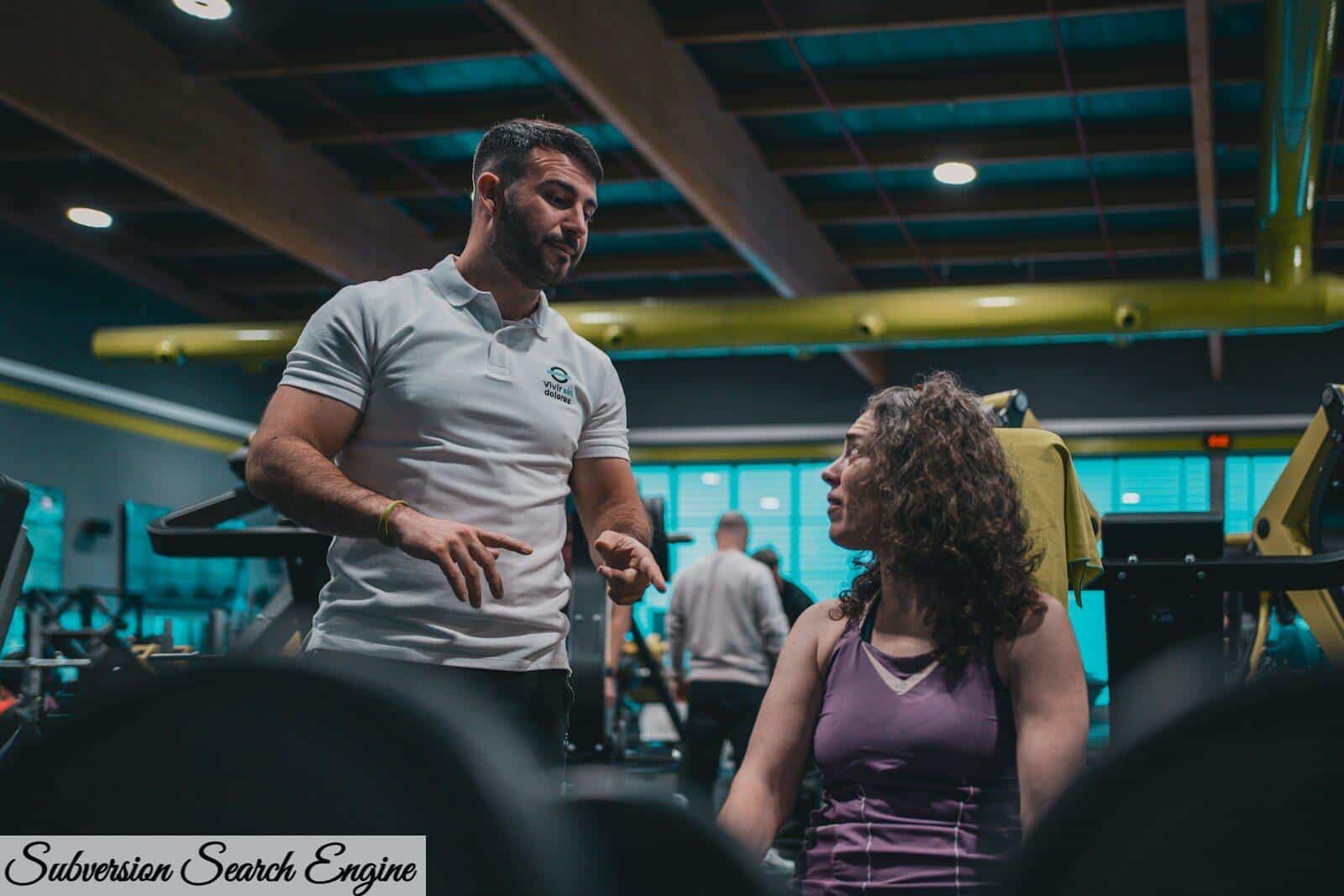 A man talking to a woman in a gym